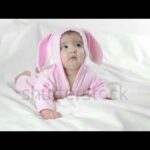 baby in bunny costume on a white background