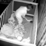 Baby caught on nursery cam playing hockey in his crib