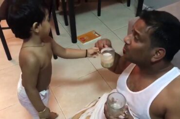 Funny Baby fights for Tea with his dad