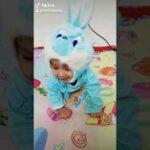 5 month  cute  baby wearing  bunny  costume and enjoy a lot