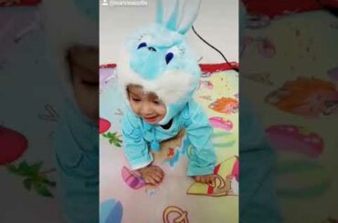 5 month  cute  baby wearing  bunny  costume and enjoy a lot