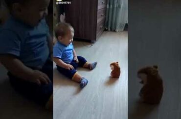 Cute baby scared by toy