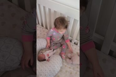Aleksia caring for her toy baby and bunny