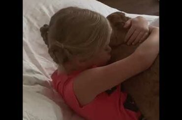 Little Girl Cuddles With Rabbit in Bed - 1122256