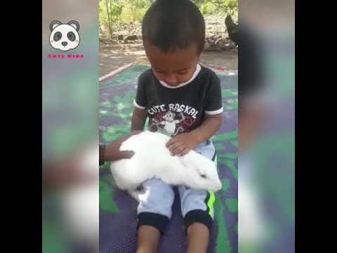 Cute baby playing with cute rabbit