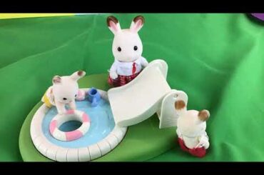 Calico Critters baby bunny playing on the sand castle.