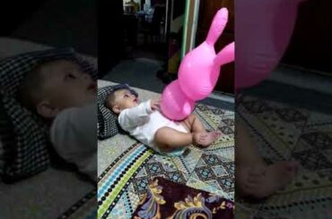 Rayyan baby is playing with Rabbit Ballon at age of 4 months