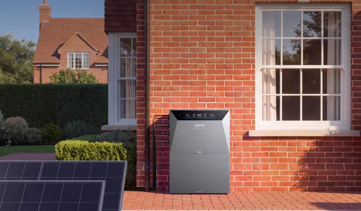 A solar panel setup next to a brick wall with an Anker connected energy storage unit.