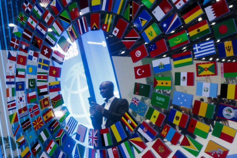 A man holds a phone as he attends the IMF-World Bank 2026 Annual Meetings at Queen Sirikit National Convention Center (QSNCC) in Bangkok on Tuesday. REUTERS